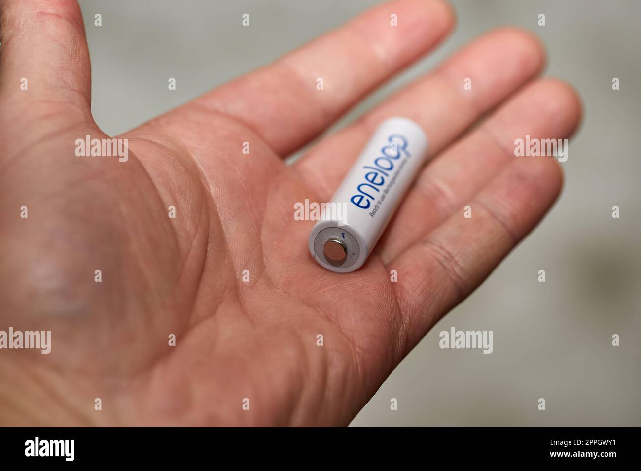 1.5 Volt AA Battery in hand Stock Photo