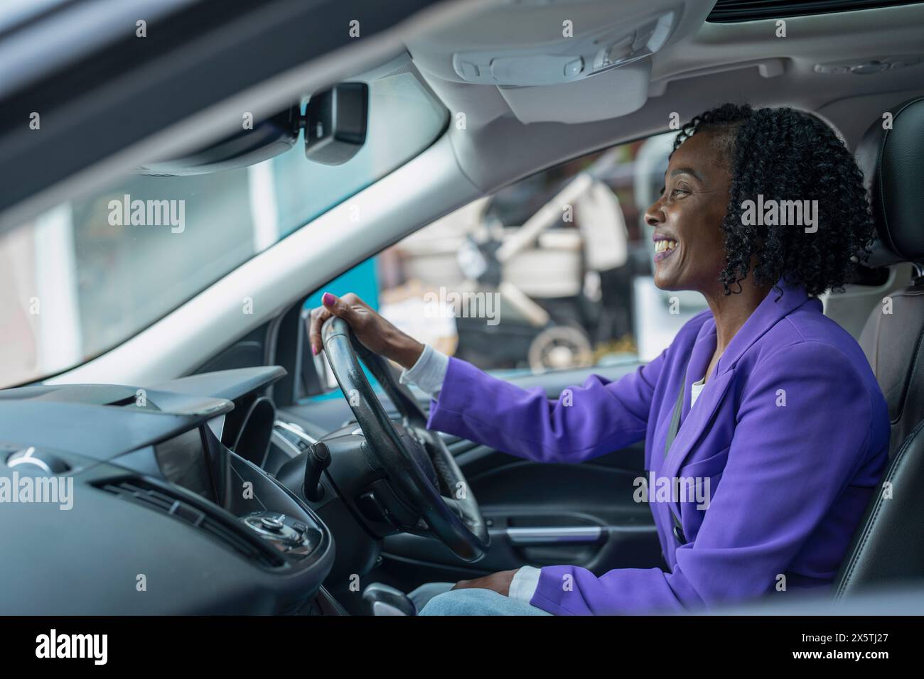 Confident woman driving car Stock Photo