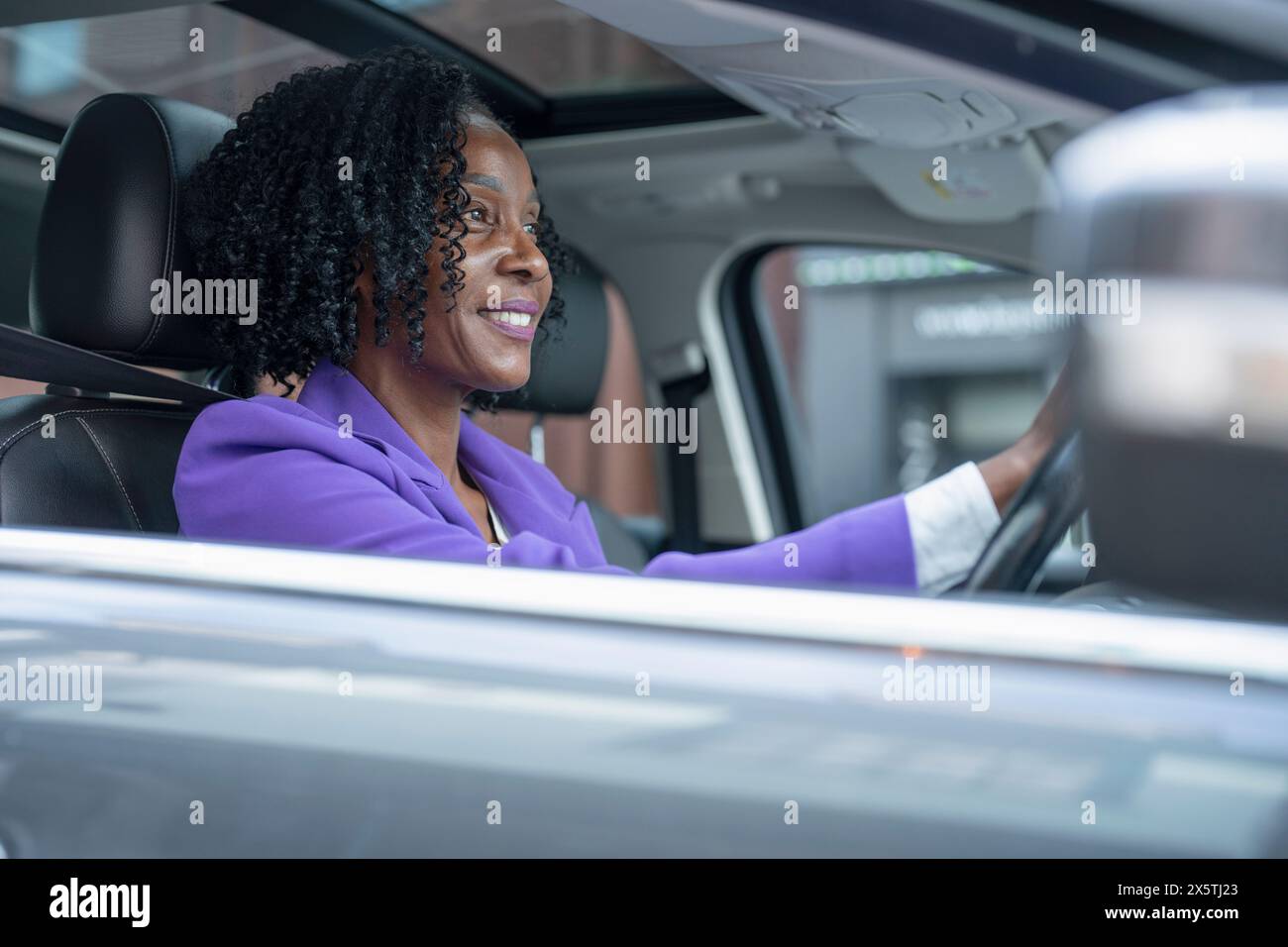 Smiling woman driving car Stock Photo