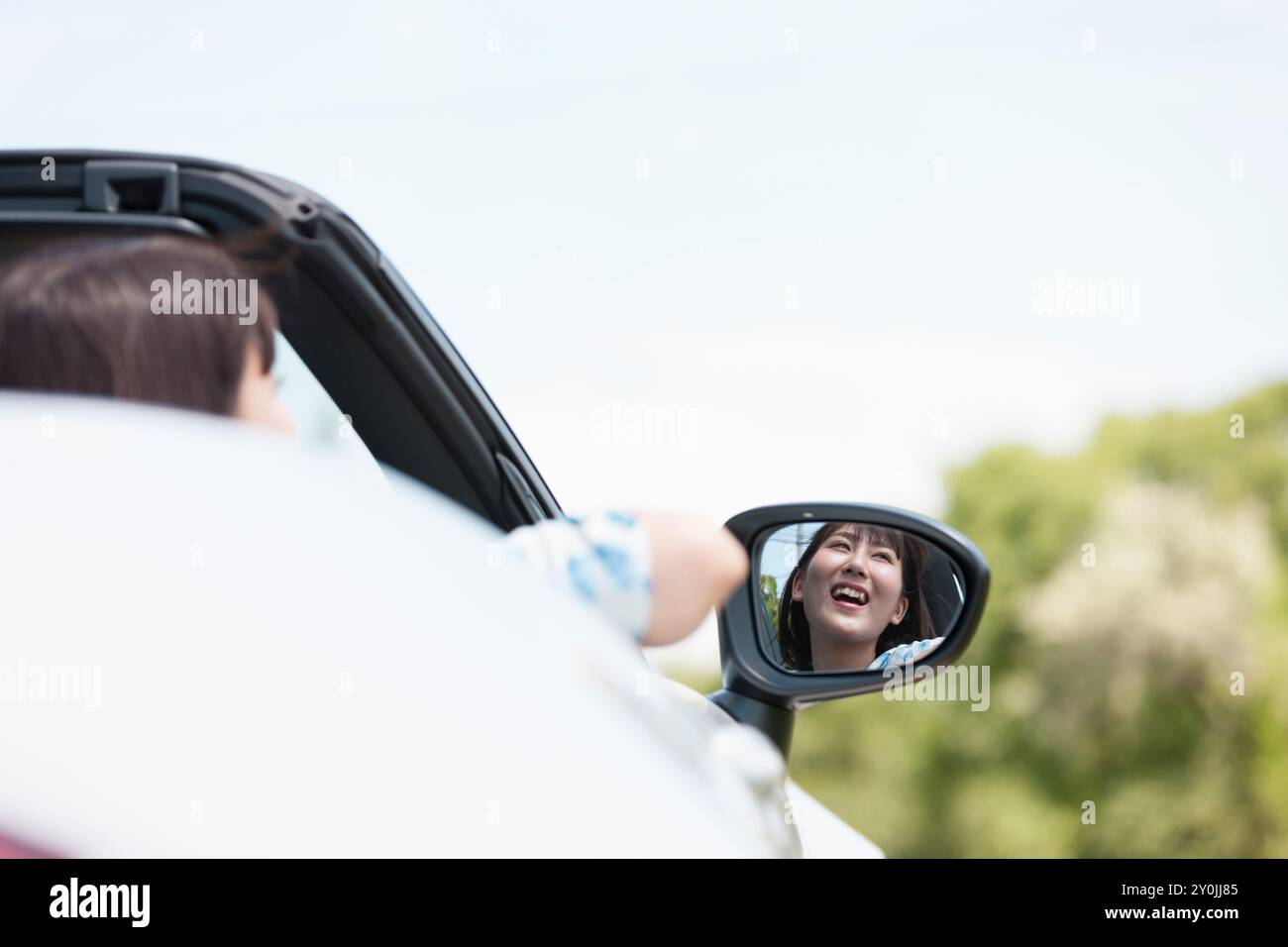 Woman in Side Mirror Stock Photo