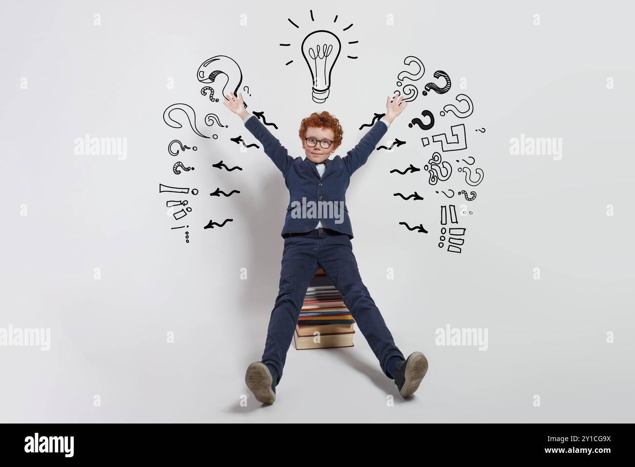 Thinking child boy on white background with light bulb and question marks. Brainstorming and idea concept Stock Photo