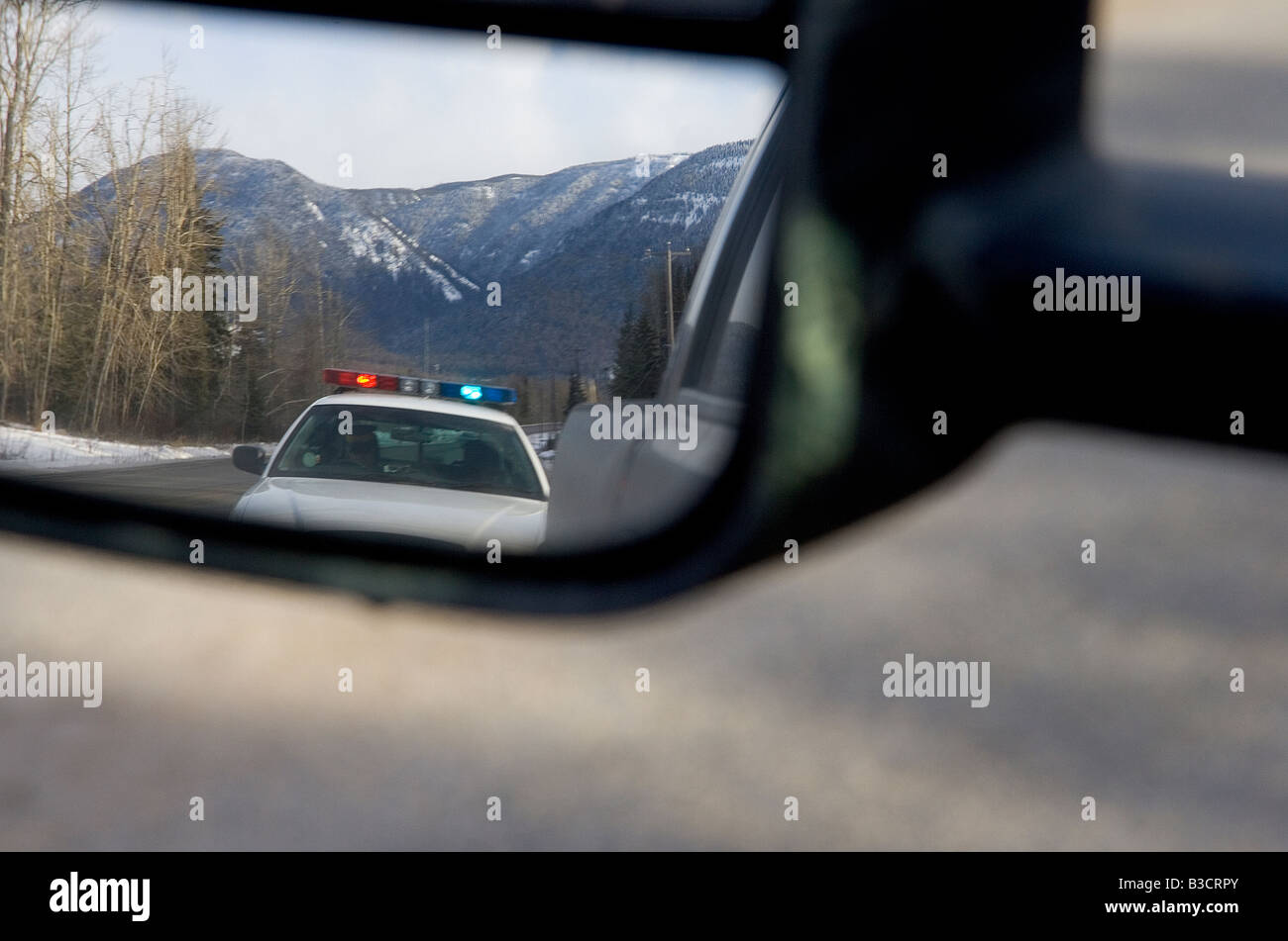 Police car in rearview mirror Stock Photo