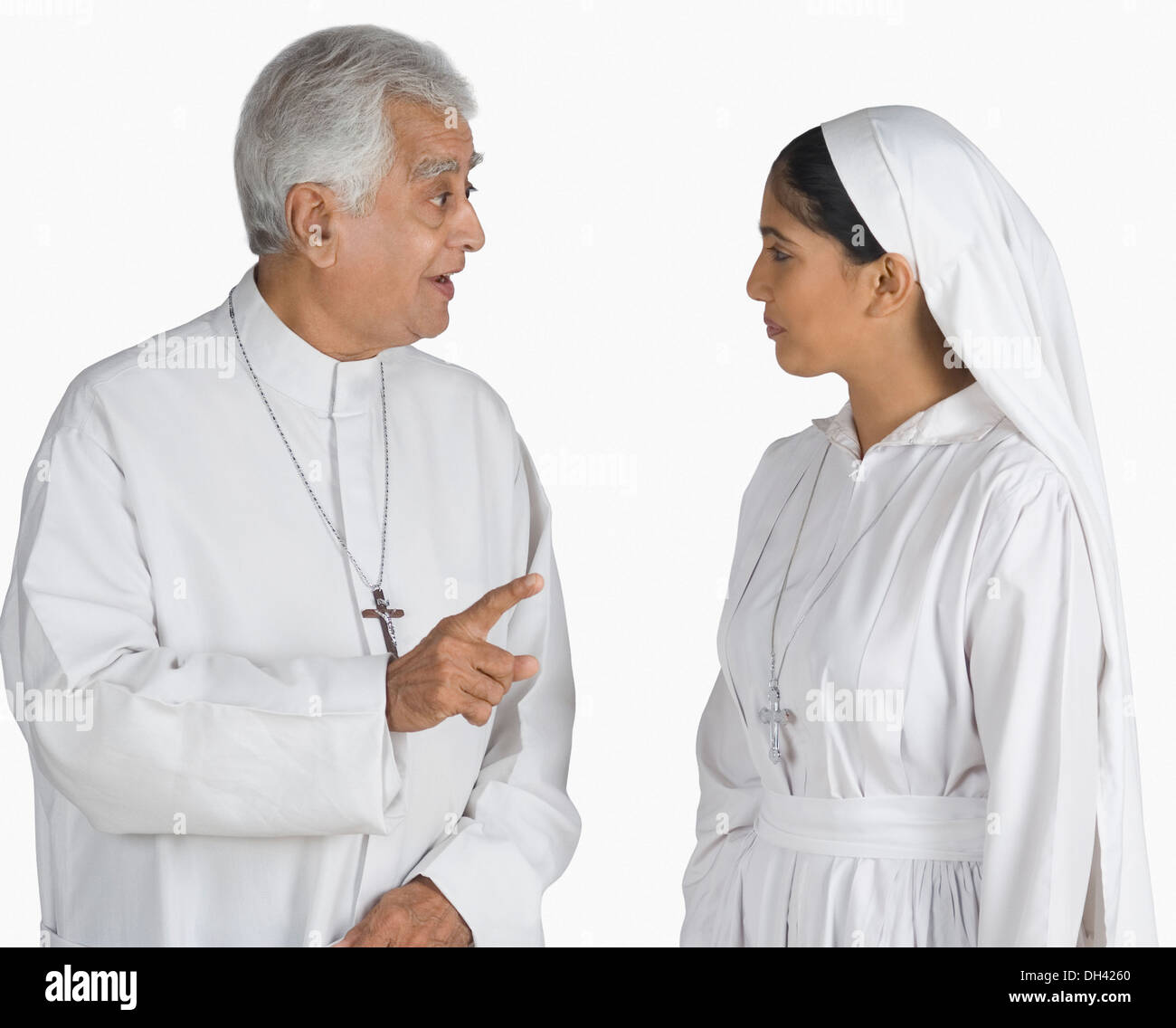 Priest talking to a nun Stock Photo