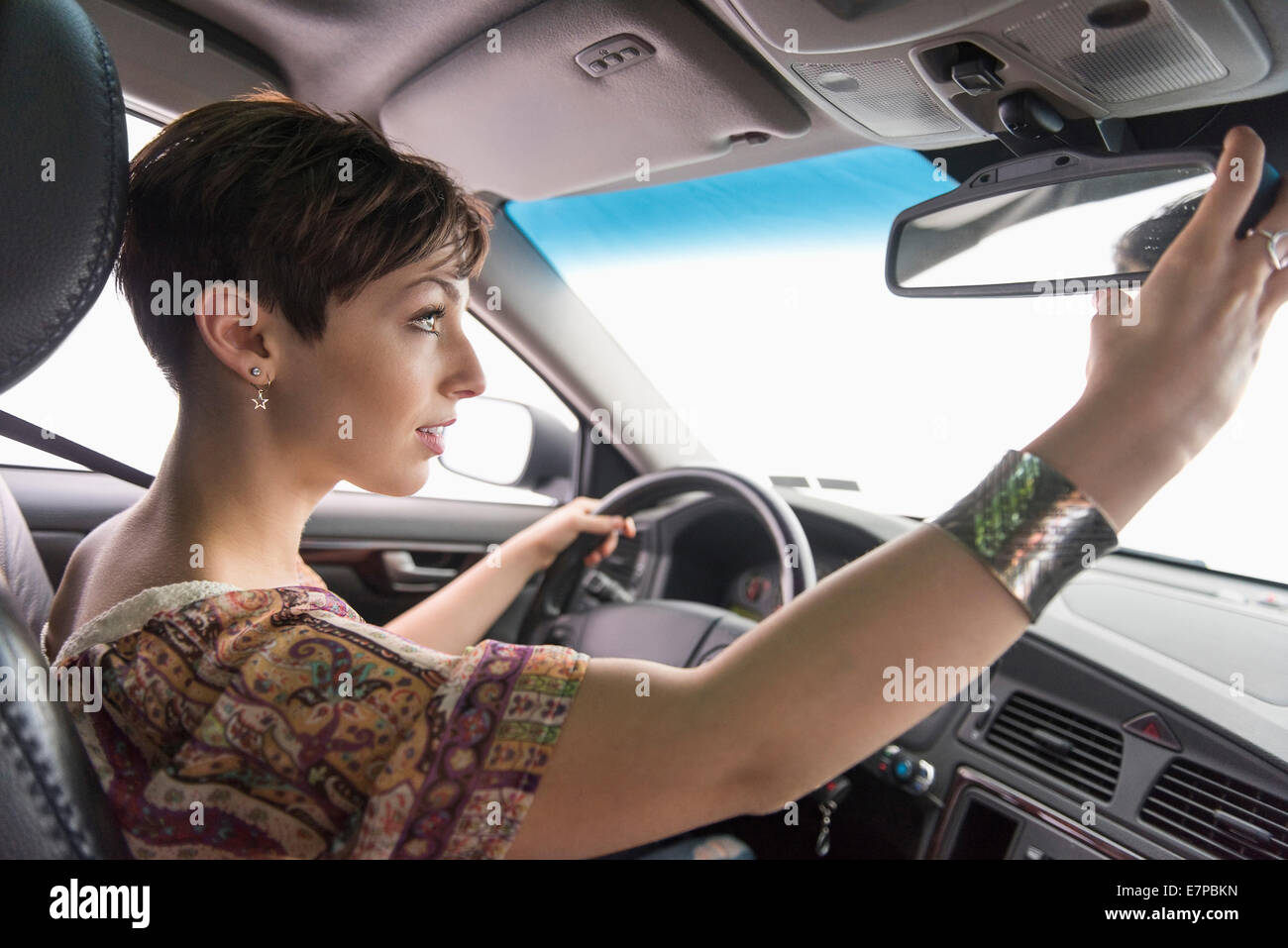 Side view of woman driving car Stock Photo