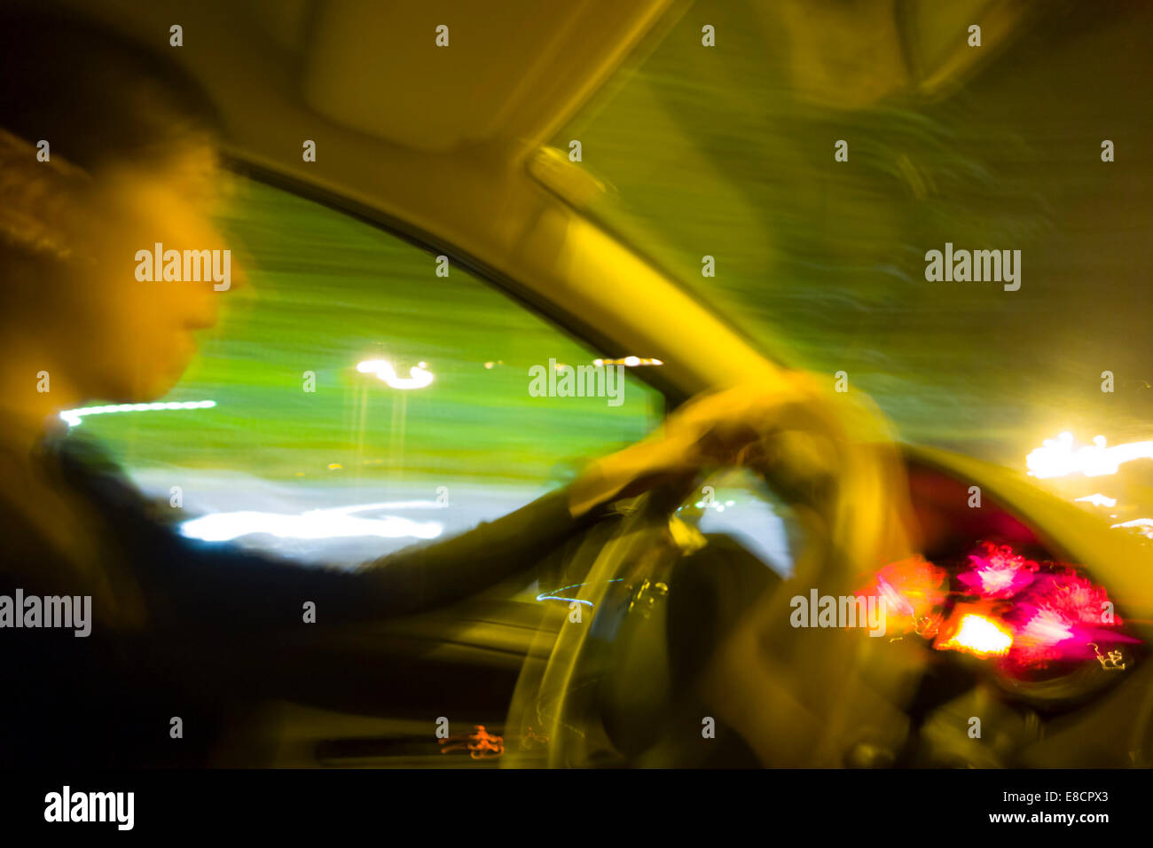 Woman driving car at night Stock Photo