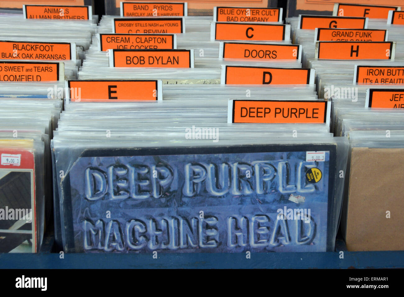 Vintage rock music vinyl records for sale archived in alphabetical order and album sleeve for Machine Head by Deep Purple. Stock Photo