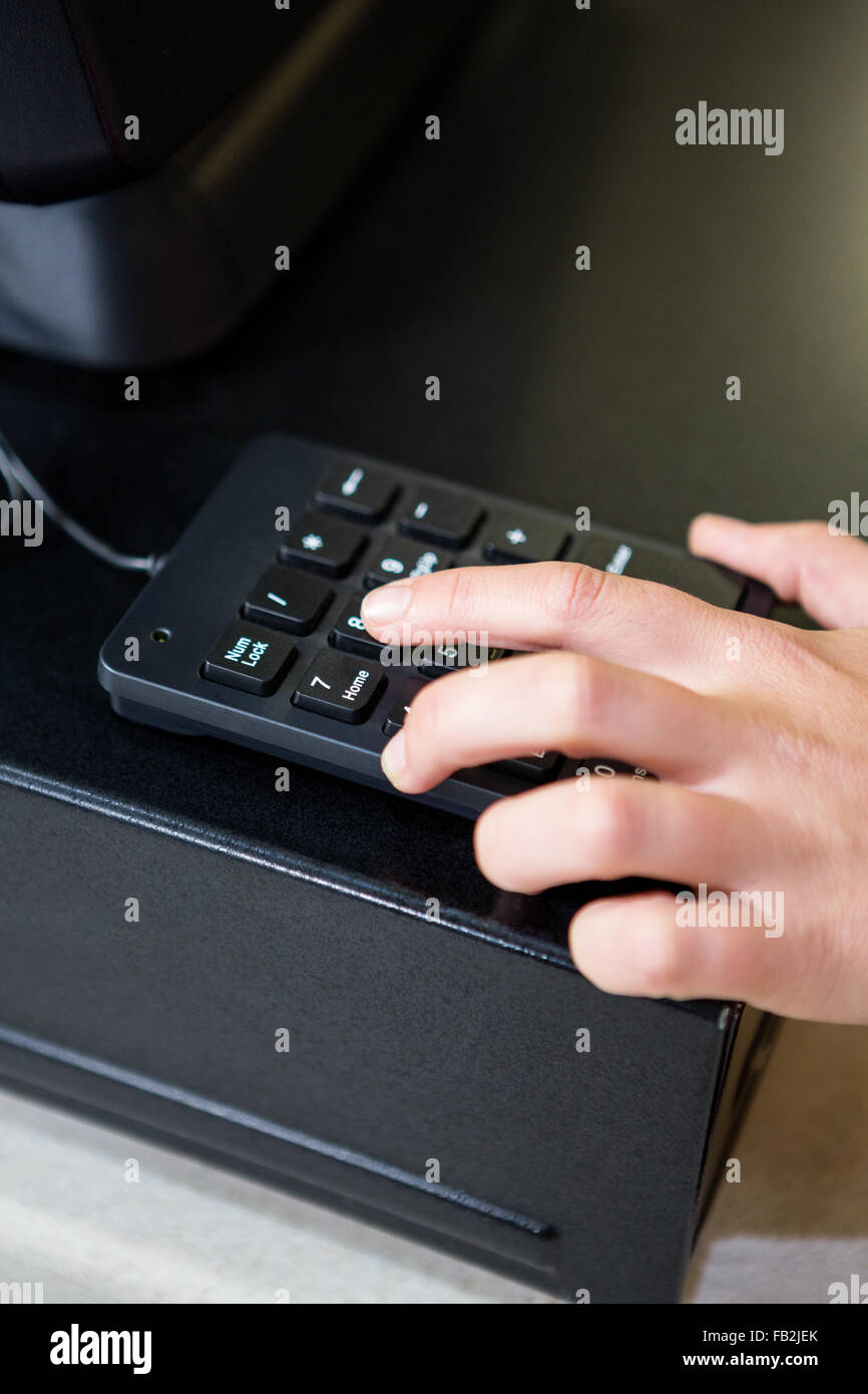 Womans hand holding calculator Stock Photo