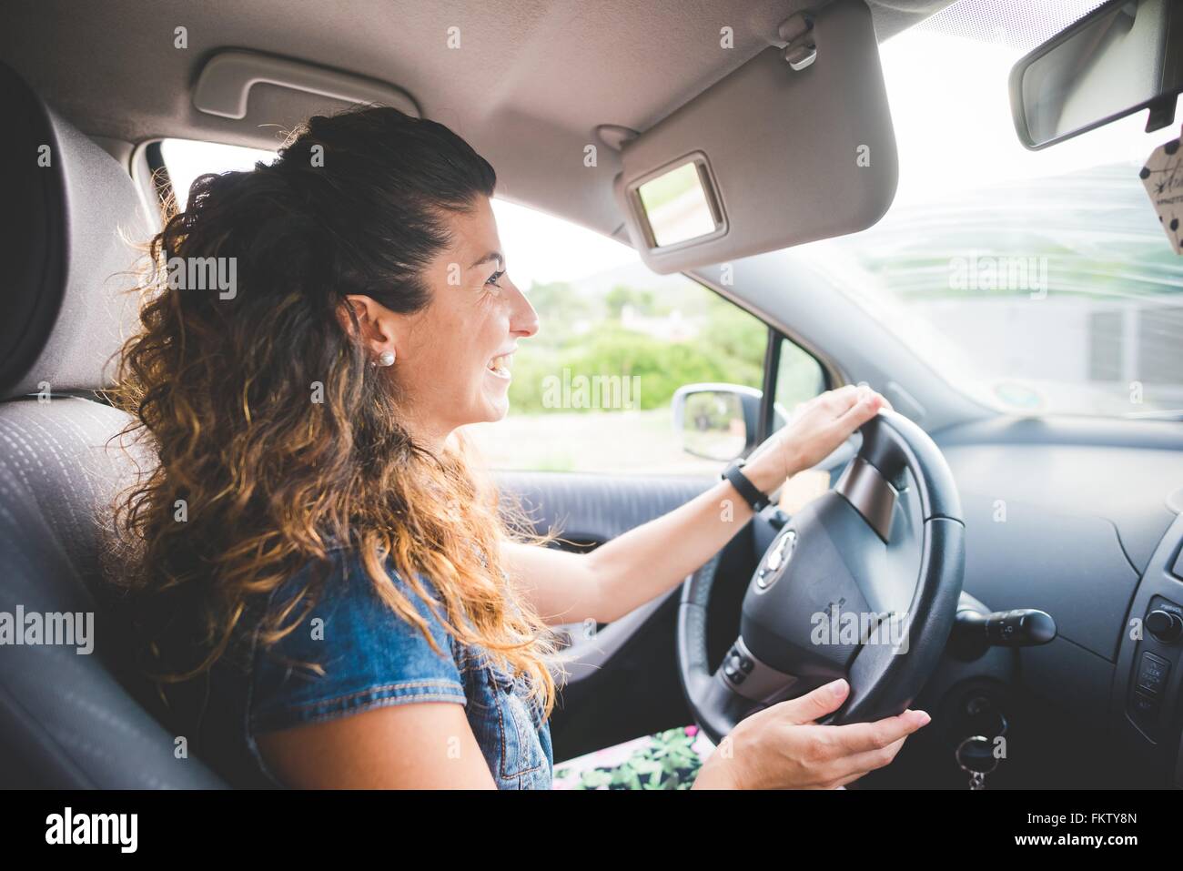 Happy woman driving a car Stock Photo