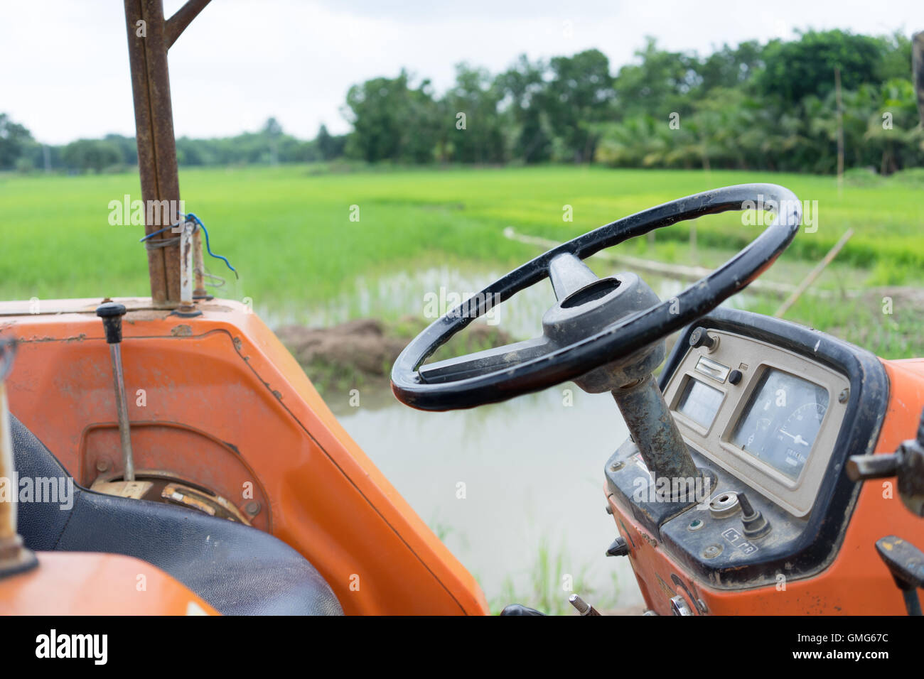 Tractor in a rice field Stock Photo