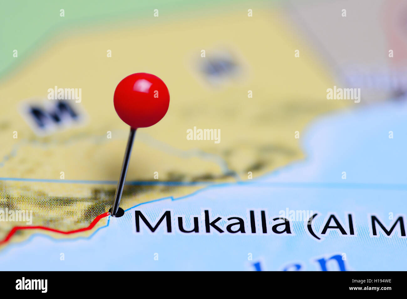 Mukalla pinned on a map of Yemen Stock Photo