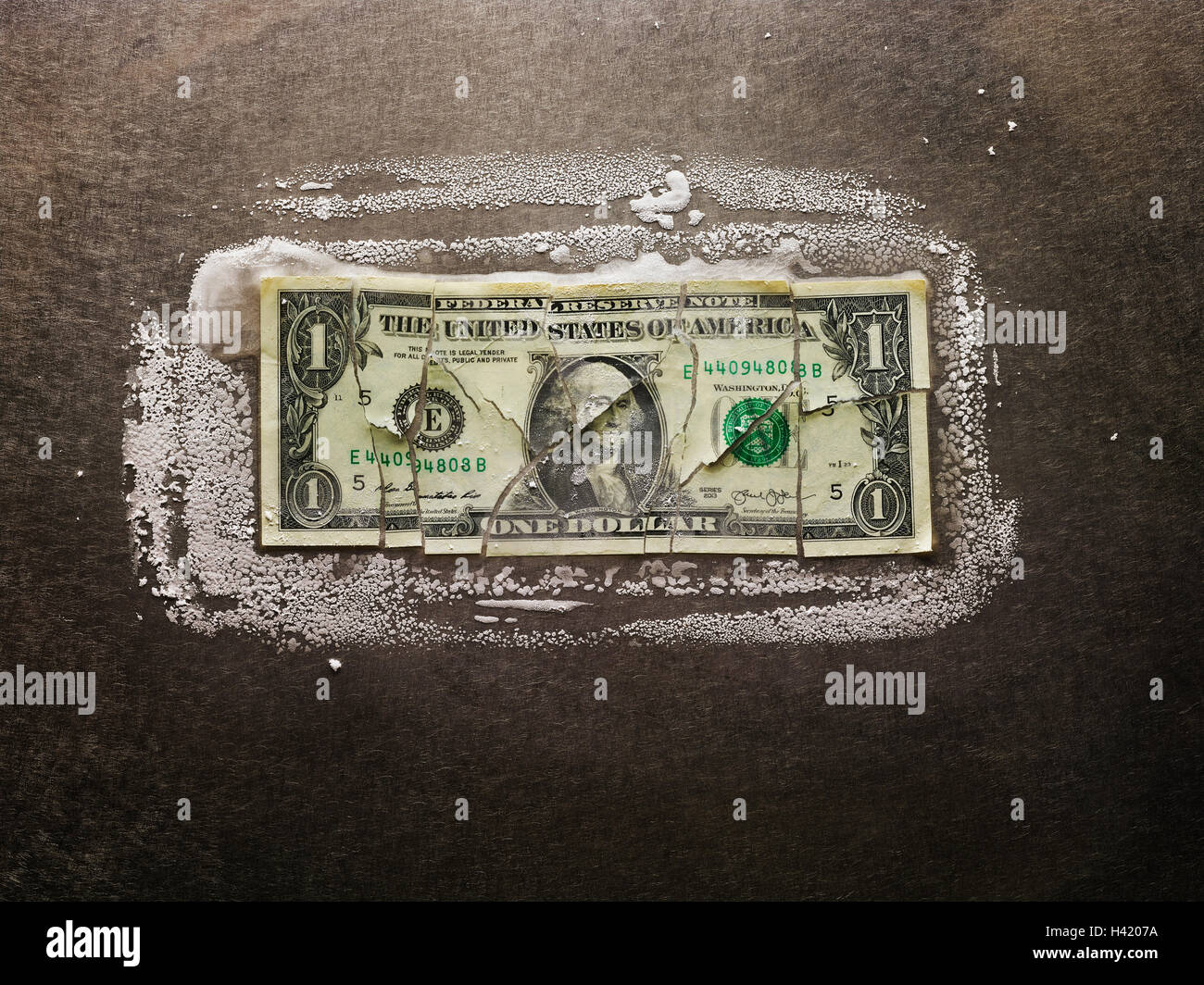 Frozen broken dollar bill Stock Photo