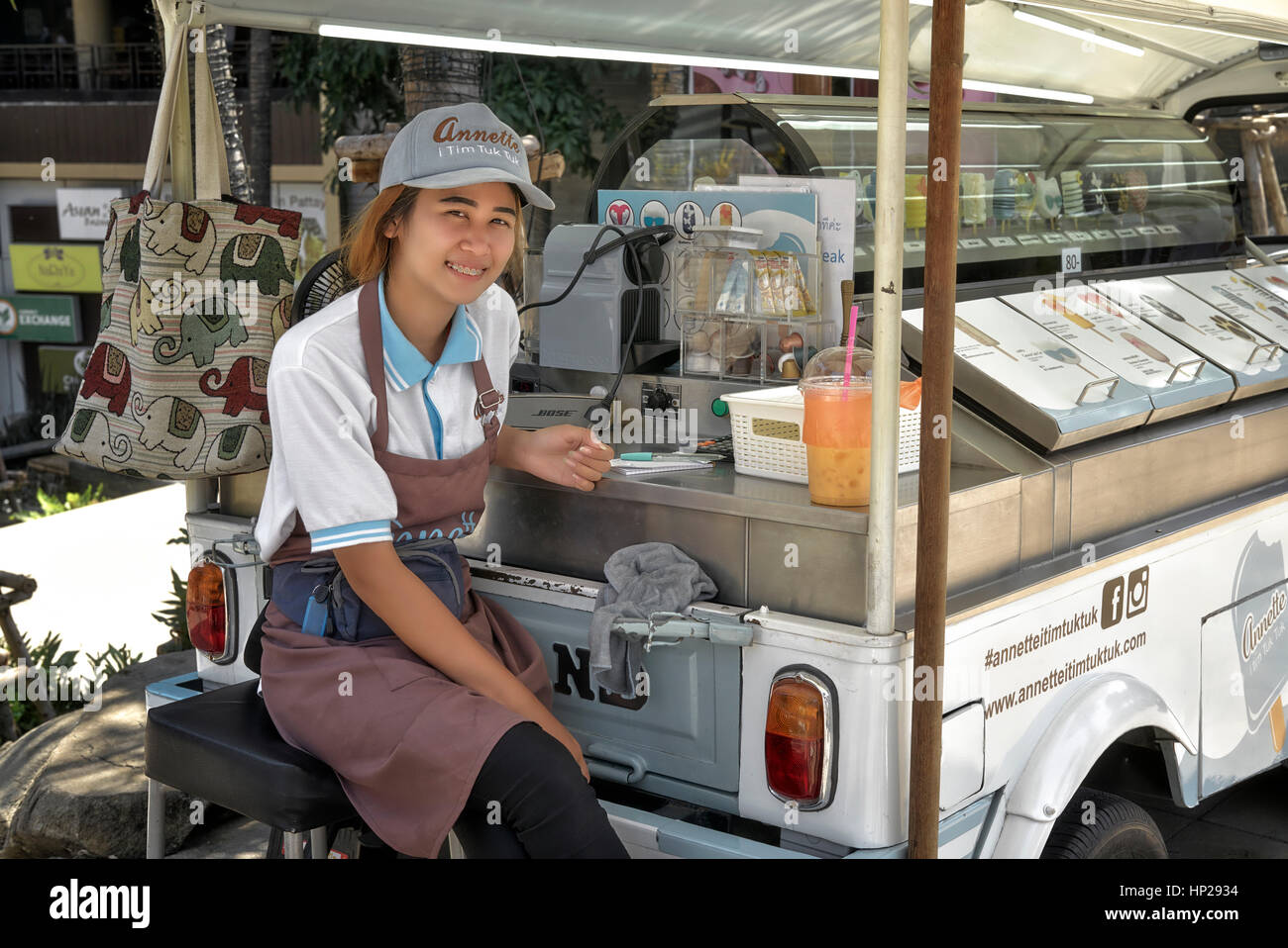 Thailand street vendor. Happy and smiling young Thai ice cream female vendor at her converted mobile vending Tuk Tuk. Pattaya Thailand Southeast Asia Stock Photo