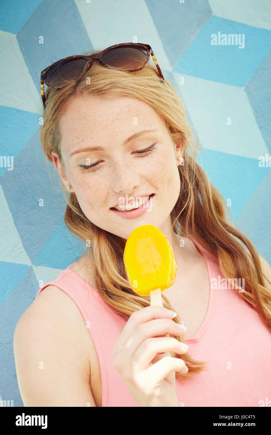 Woman looking down at ice lolly Stock Photo