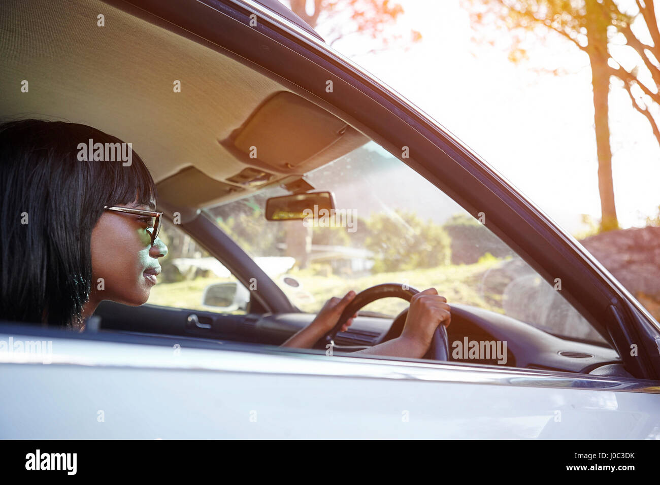 Young woman driving car Stock Photo