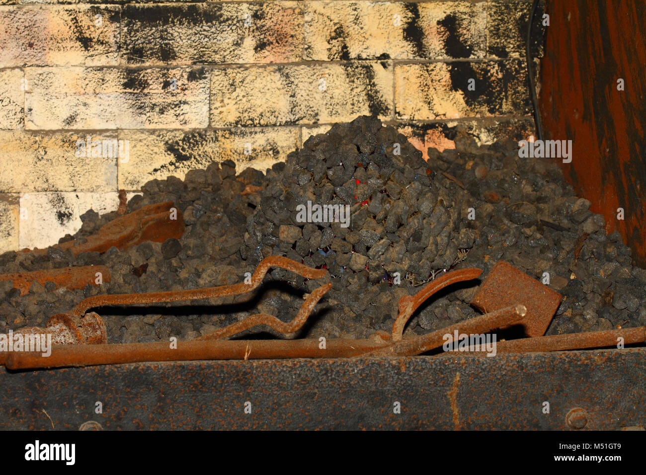 Coal fire with brass tools Stock Photo