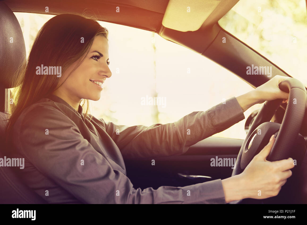 Happy woman driving a car Stock Photo