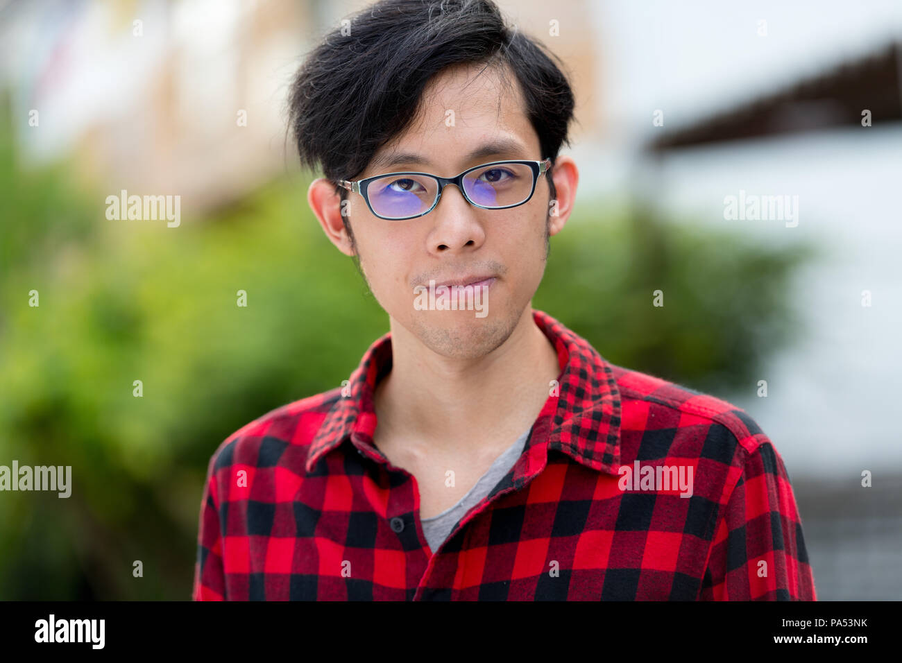 Young Asian man outdoors Stock Photo