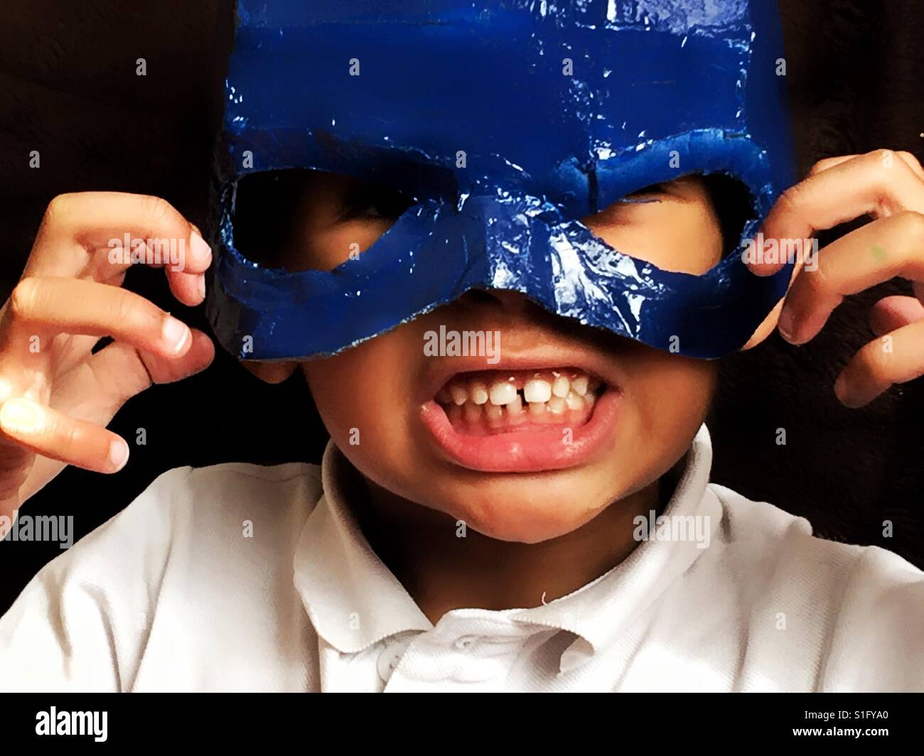 Little boy in a superhero mask. Stock Photo