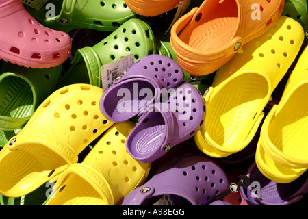 Kids beach shoes. Colorful footwear for boy or girl. Group of children  wearing aqua shoe playing on tropical beach on summer vacation. Water and  sand Stock Photo - Alamy