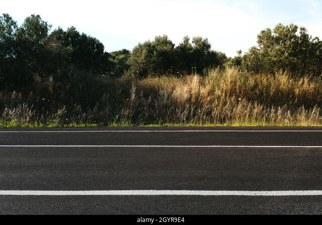 Side view of Empty straight country road background in the evening Stock  Photo - Alamy