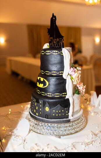 A stunning traditional but fun Batman wedding cake, a half and half cake  made for the special wedding occasion, tasty and elegant Stock Photo - Alamy