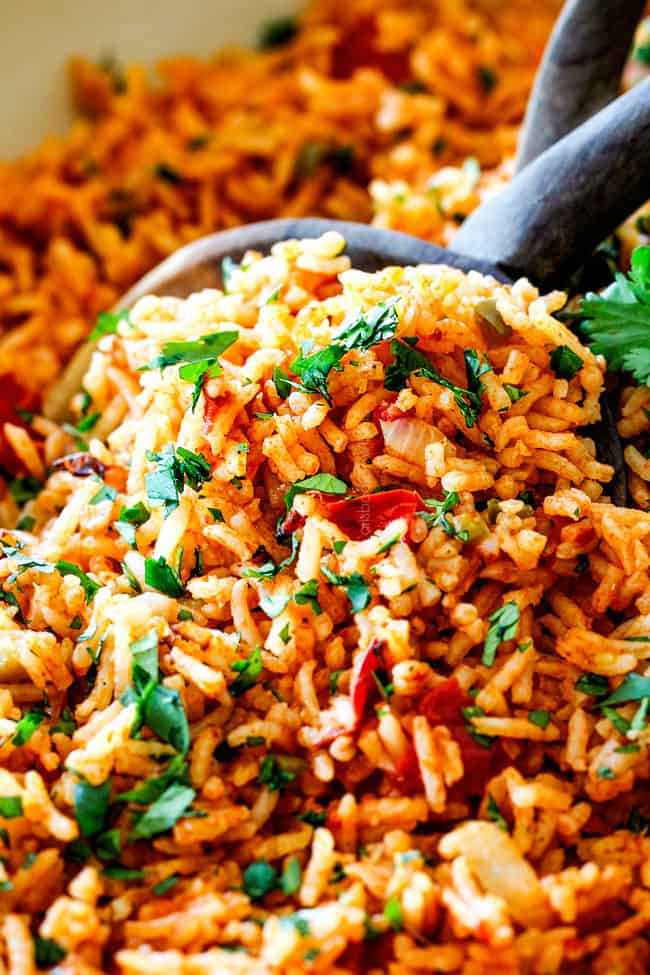 up close of easy Mexican rice in a wooden spoon