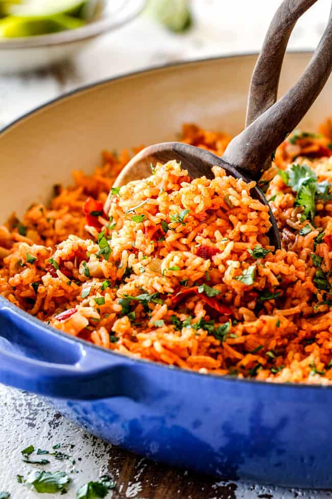 best Mexican Rice in a blue skillet with the optional peas, corn and carrots