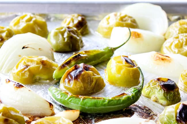 showing how to make roasted salsa verde with charred tomatillos, serranos and onions on baking sheet