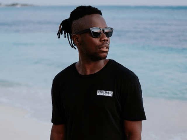 man wearing black shirt on sea side