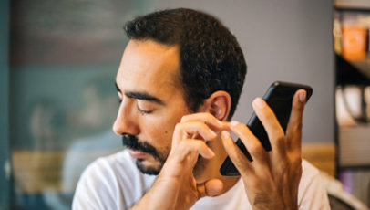 Visually impaired man using a smartphone.