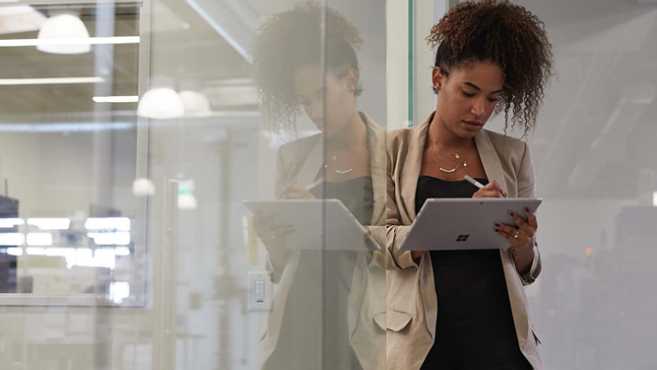 A woman writes with Surface Pen on a Surface tablet