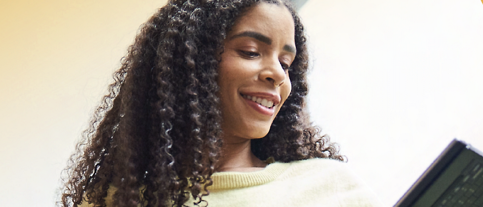 A women looking into the tap screen and smiling