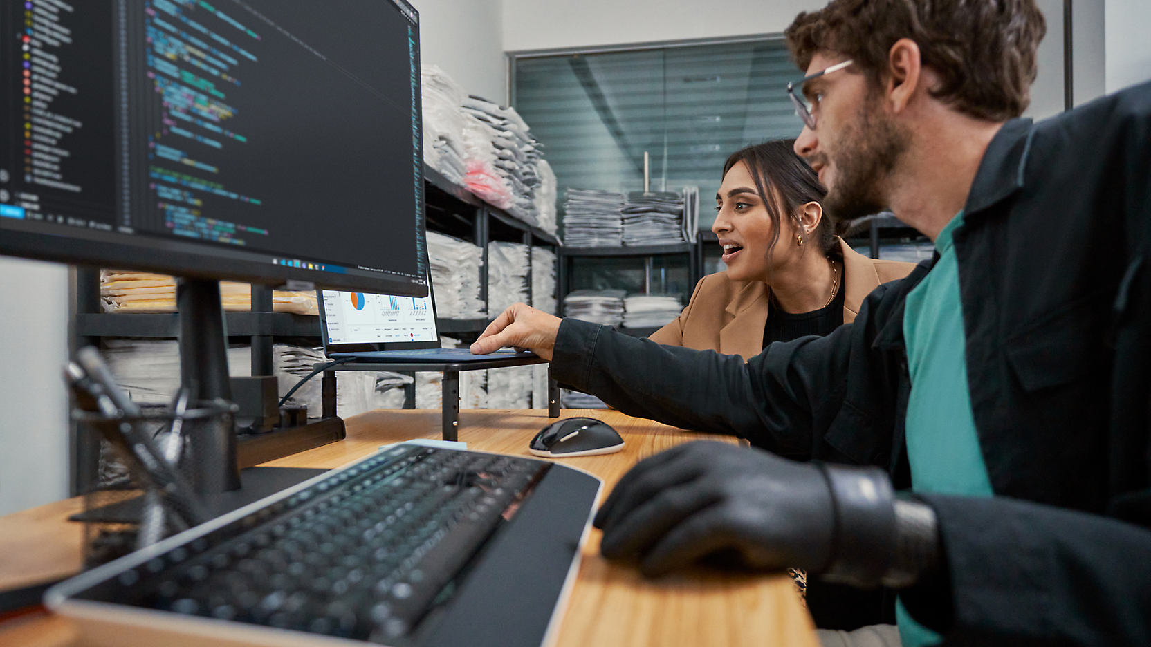 A person and another person looking at a computer screen