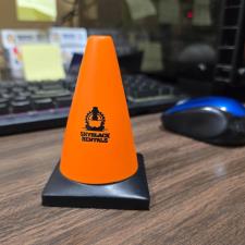 an orange cone on a desk