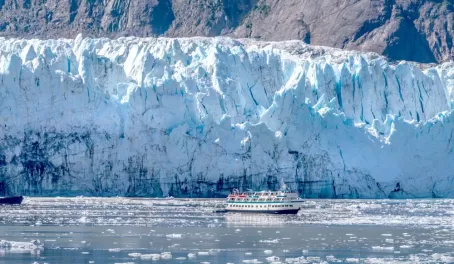 A small ship gets close to the glacier for a better look