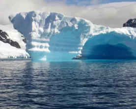 Beautiful blue icebergs emerge from the ocean.