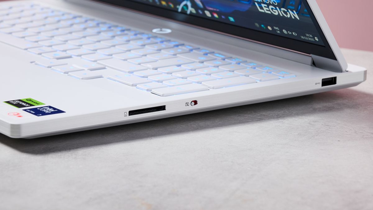Close-up of right-side ports on Lenovo Legion 7i Gen 10 on desk with pink wall in background