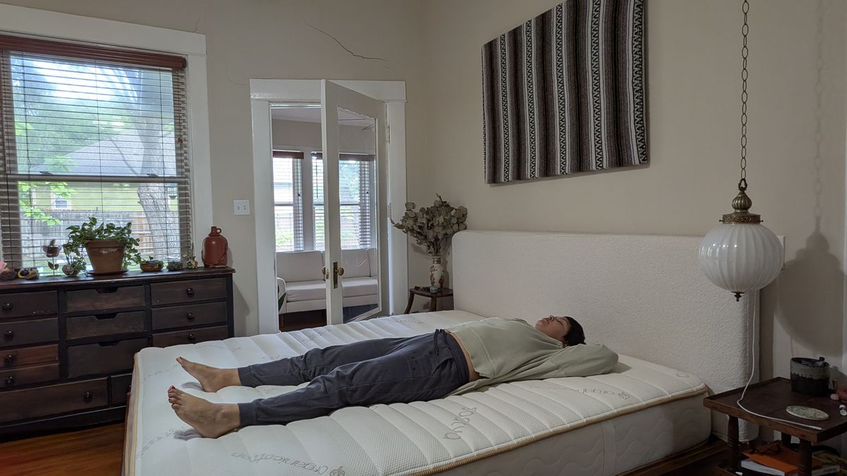 Tom's Guide mattress tester lying on her back on the Saatva Zenhaven Latex mattress in her bedroom.