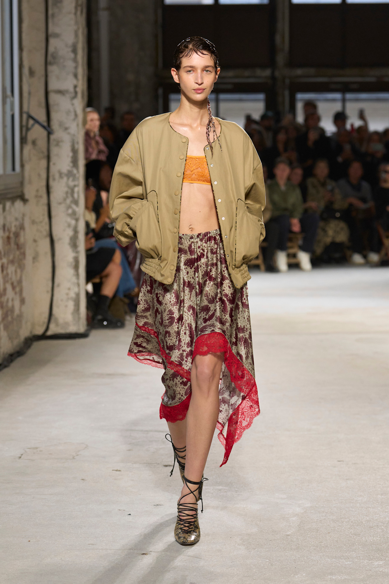 A model wore a lace-trimmed satin skirt on the Dries Van Noten Spring 2025 runway.