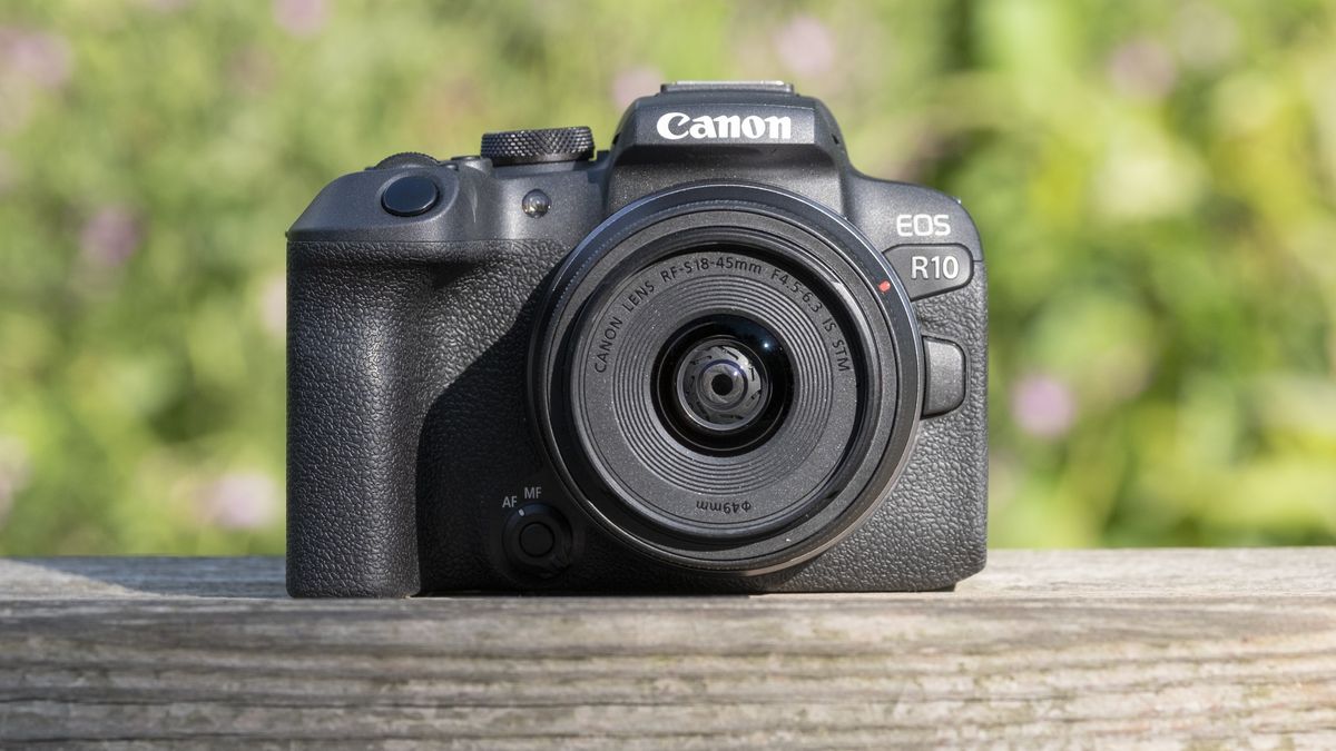 The Canon EOS R10 camera on a wooden shelf