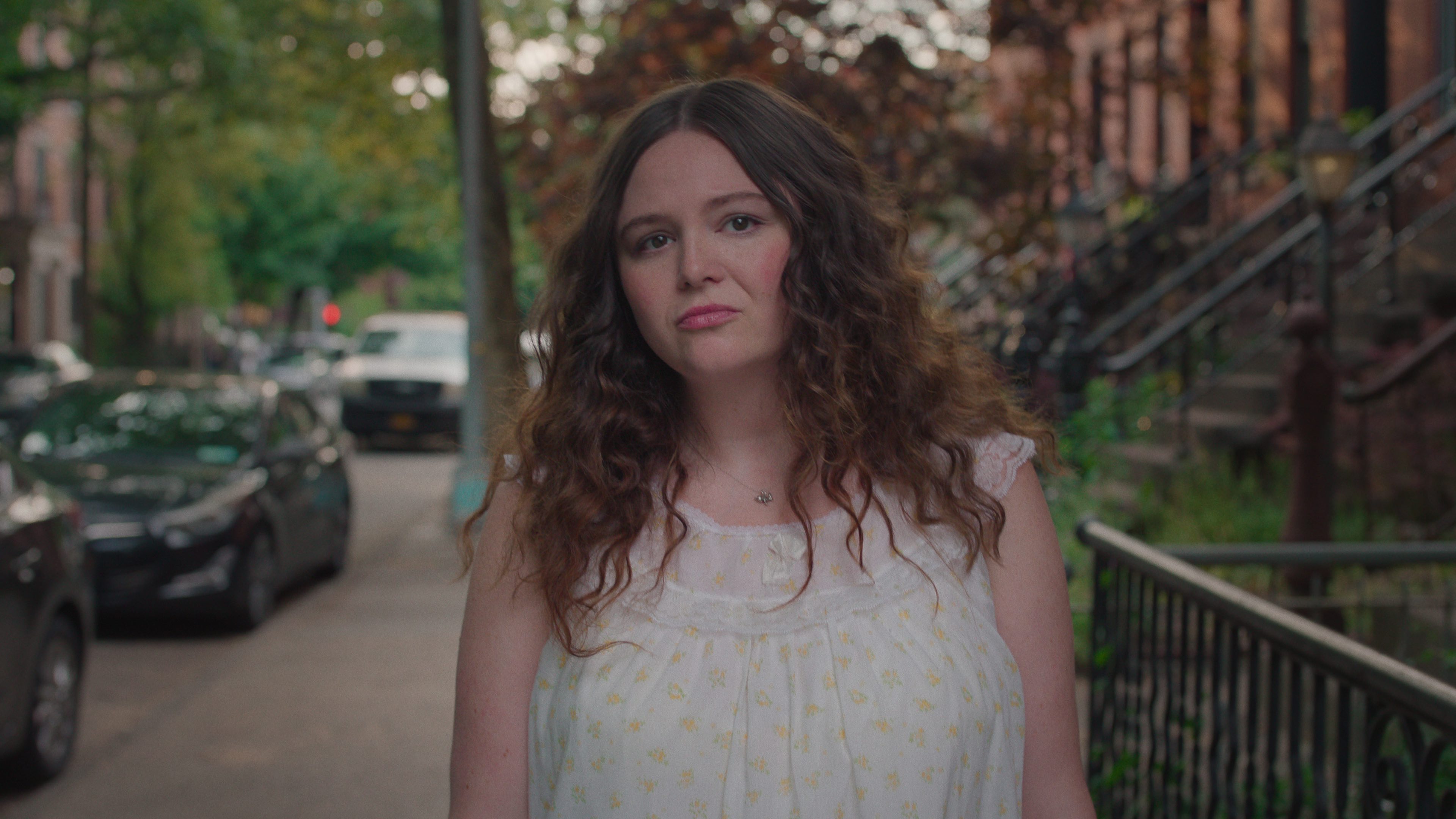megan stalter as jessica walking down a brooklyn street in too much