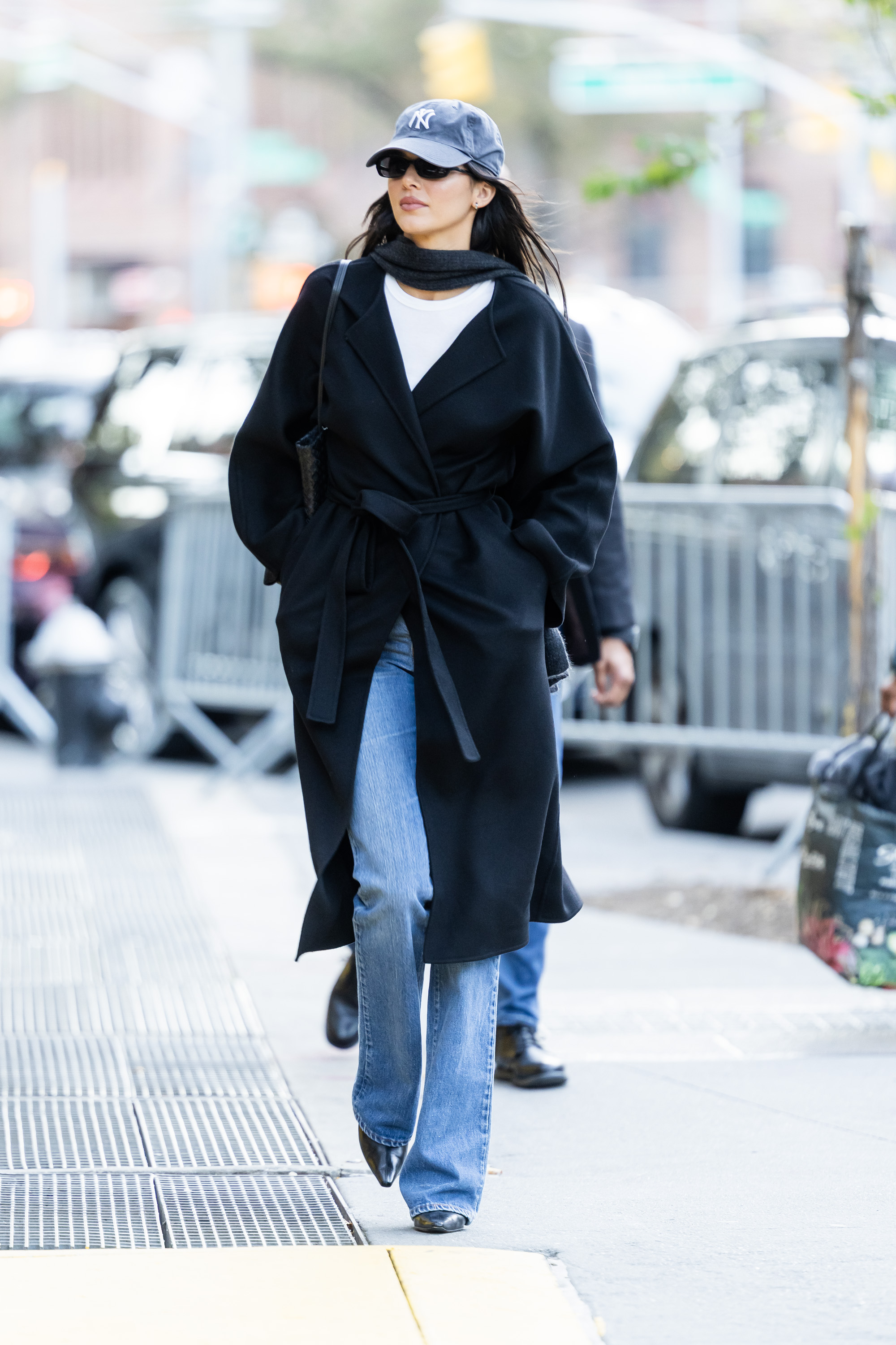 Kendall Jenner was spotted in NYC wearing an incredibly shoppable outfit: bootcut jeans, a black wrap coat, and pointy boots