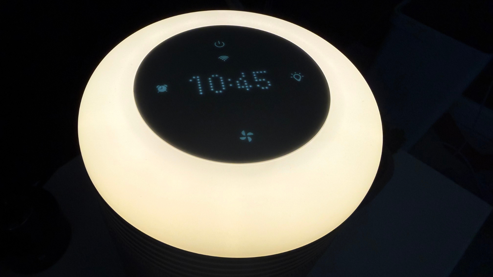 Touchscreen display on the Blueair Mini Restful showing the time, alarm status, fan settings and light controls