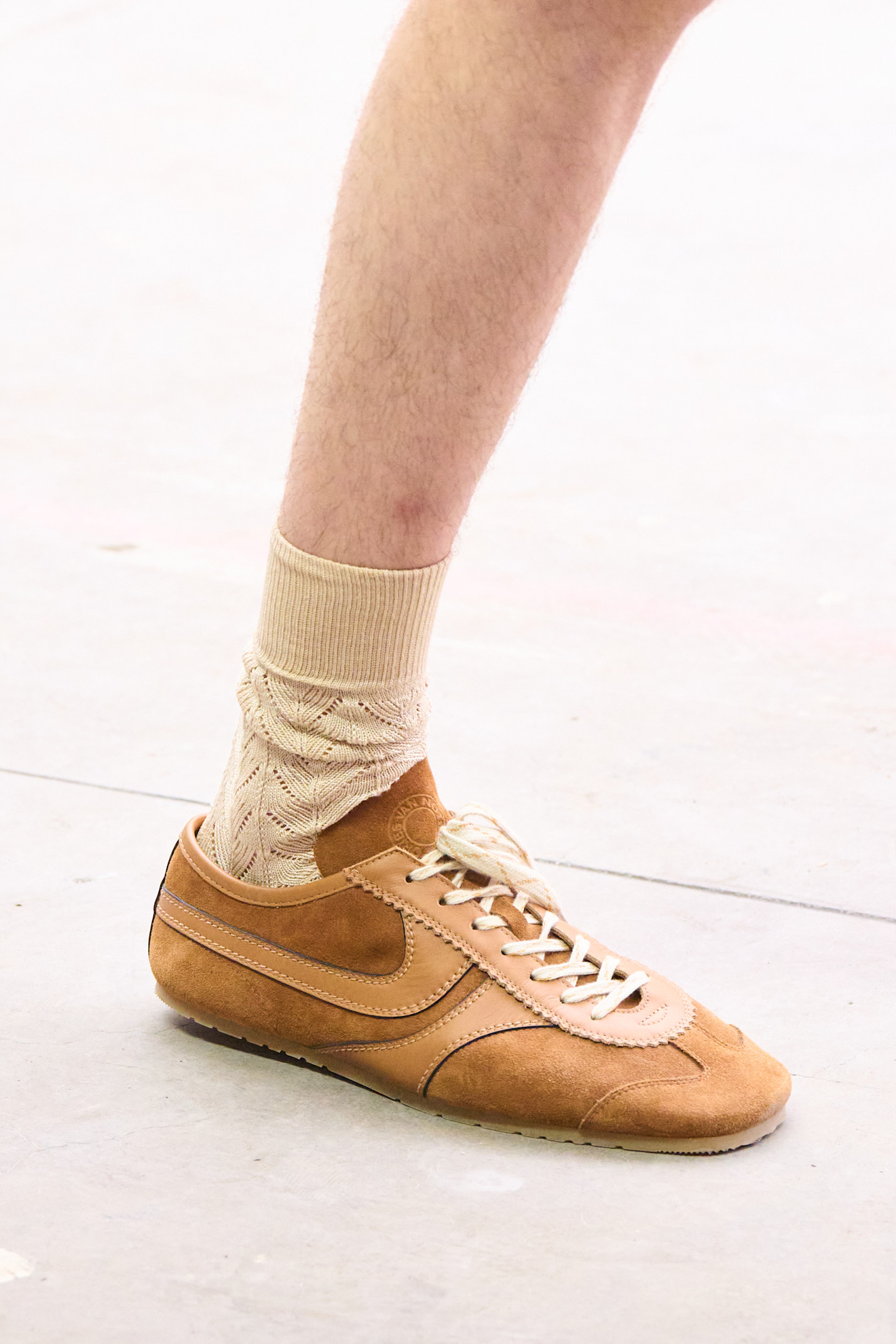 The Dries Van Noten Spring/ Summer26 runway show. And image of the brown suede Leather Sneakers