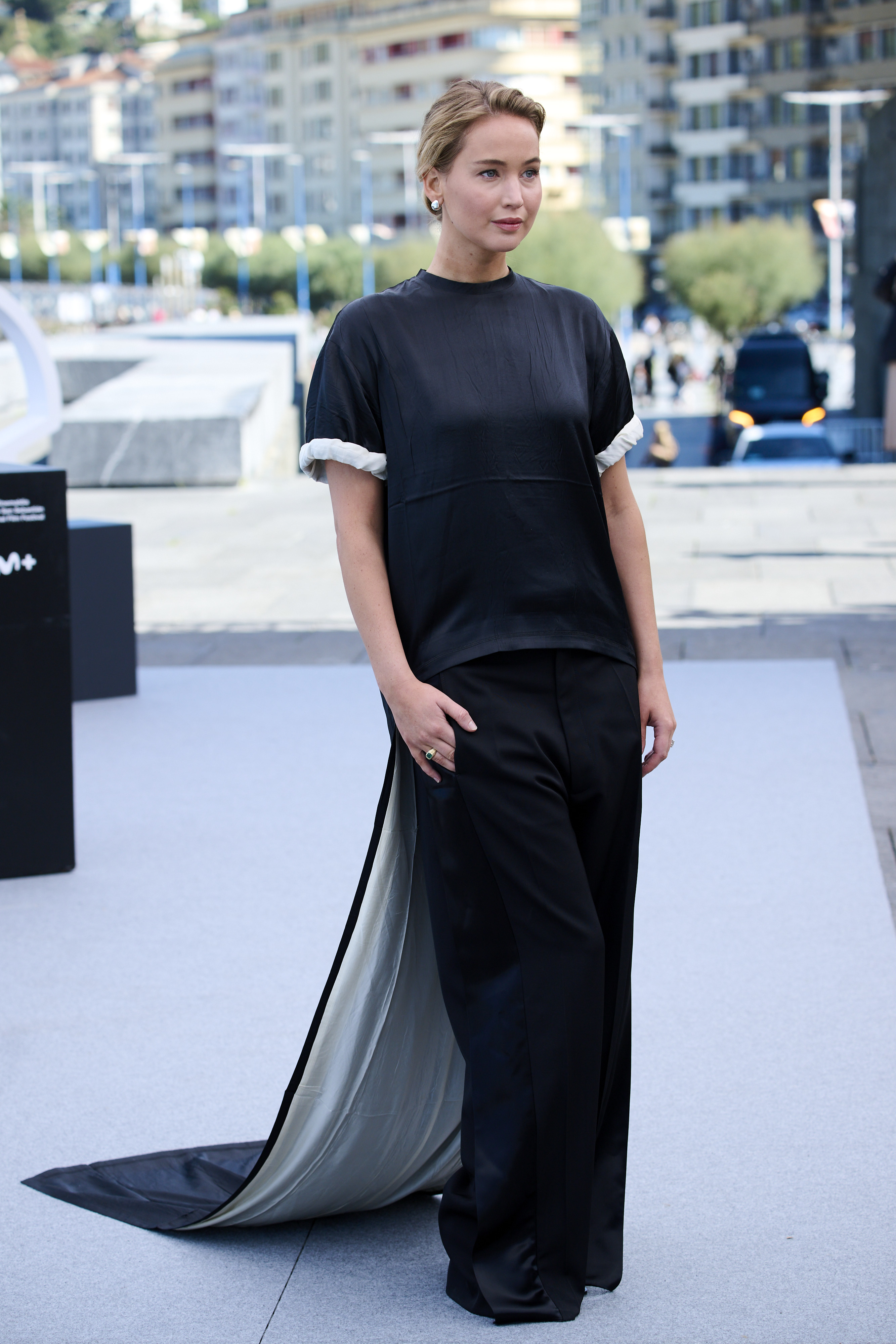 Jennifer Lawrence attended a film festival in spain wearing a T-shirt, pants, and a dress-like train