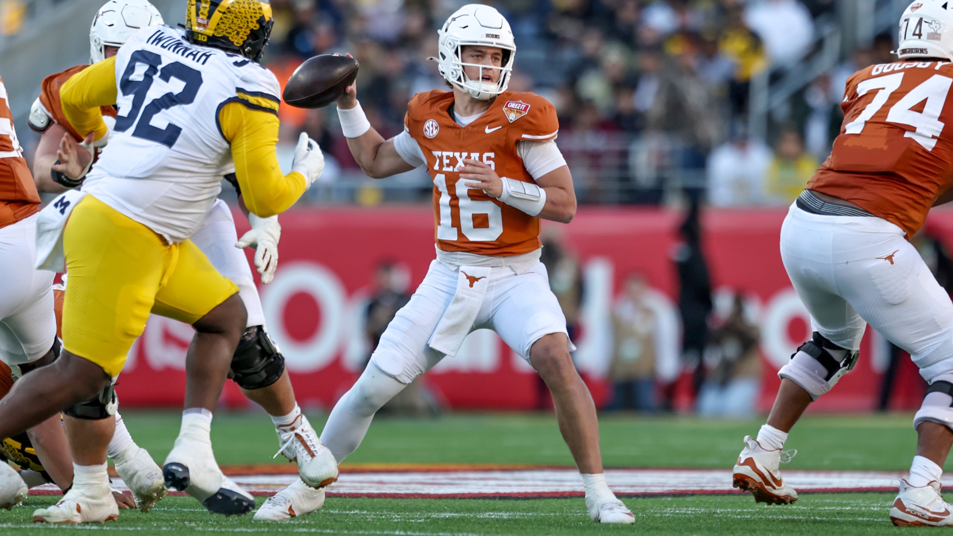 Arch Manning of the Texas Longhorns looks for a pass during an NCAA college football match.