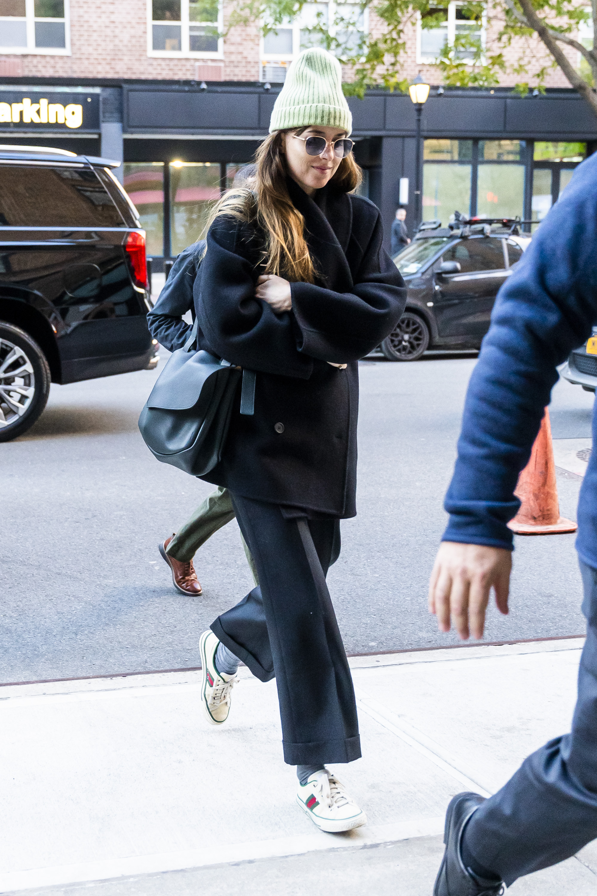 Dakota Johnson wears Gucci sneakers in NYC.