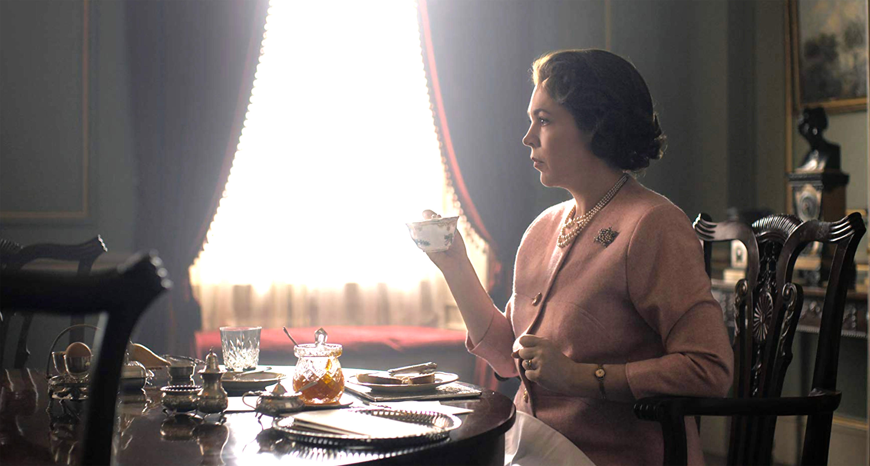 olivia colman as queen elizabeth sipping tea in the crown