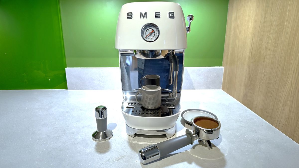 Smeg ECF03 espresso machine with portafilter and tamper on kitchen counter