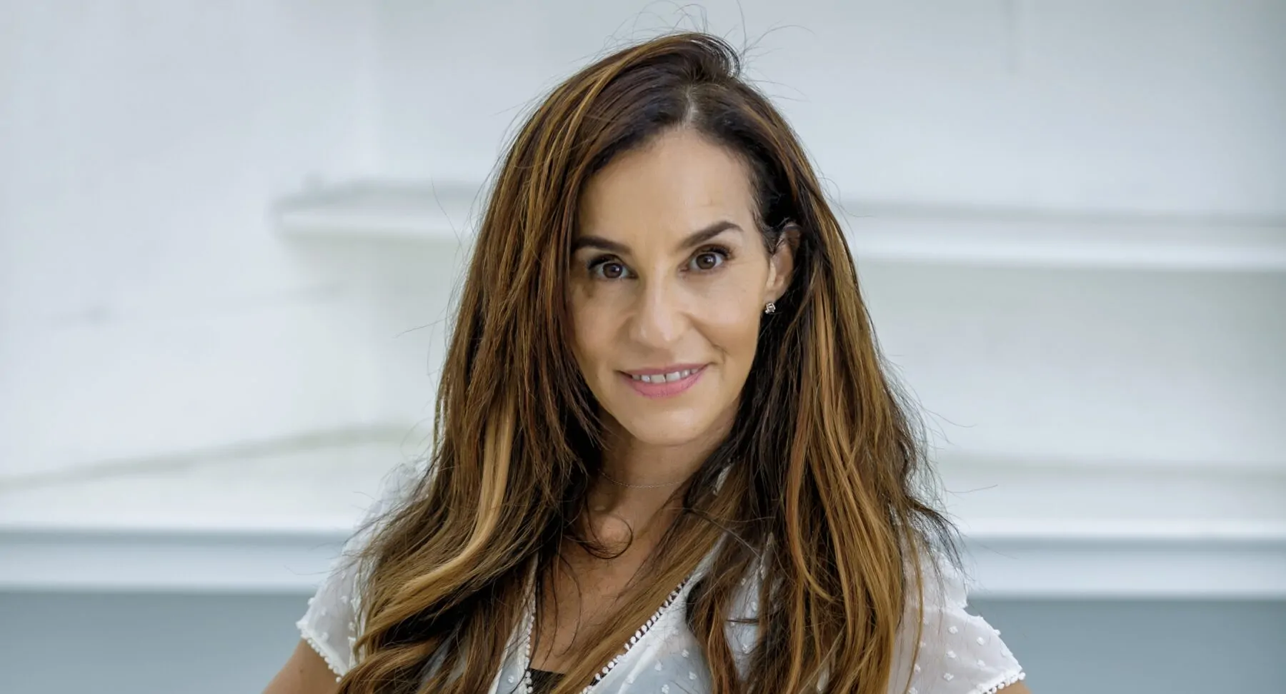 A brunette woman smiling at the camera
